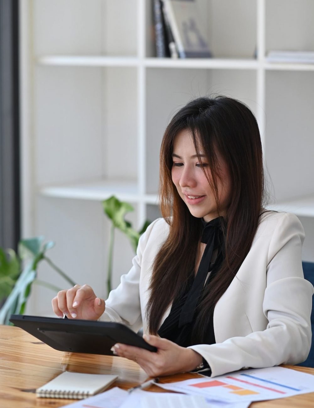 thoughtful-business-woman-checking-financial-data-on-digital-tablet--e1670795845192.jpg